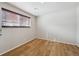 Bedroom featuring hardwood flooring and a large window offering natural light at 11782 Gilpin St, Northglenn, CO 80233