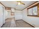 Bedroom with neutral carpet, wood trim, ceiling fan, and natural light from two windows at 11782 Gilpin St, Northglenn, CO 80233