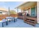 Back patio with table, chairs, and access to the house at 1040 S Fulton Ave, Fort Lupton, CO 80621