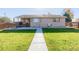 House back view, backyard with lawn and walkway at 1040 S Fulton Ave, Fort Lupton, CO 80621