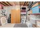 Unfinished basement storage area with shelving and ample space at 1040 S Fulton Ave, Fort Lupton, CO 80621