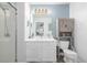 Clean bathroom with white vanity, large mirror and shower at 1040 S Fulton Ave, Fort Lupton, CO 80621