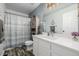 Elegant bathroom with shower/tub combo and white cabinets at 1040 S Fulton Ave, Fort Lupton, CO 80621