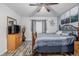 Bedroom with ceiling fan, large bed, and wood-look flooring at 1040 S Fulton Ave, Fort Lupton, CO 80621