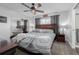 Main bedroom with ceiling fan, large bed, and ensuite bathroom at 1040 S Fulton Ave, Fort Lupton, CO 80621