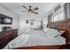 Main bedroom with ceiling fan, large bed, and ensuite bathroom at 1040 S Fulton Ave, Fort Lupton, CO 80621