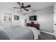 Bedroom with ceiling fan, large bed, and ensuite bathroom at 1040 S Fulton Ave, Fort Lupton, CO 80621