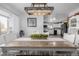 Bright dining room with farmhouse table and kitchen view at 1040 S Fulton Ave, Fort Lupton, CO 80621