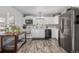 Modern kitchen featuring stainless steel appliances and wood-look flooring at 1040 S Fulton Ave, Fort Lupton, CO 80621