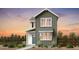 Charming two-story home with gray siding, white trim, and a welcoming blue front door at 14847 Arbor W Blvd, Thornton, CO 80602