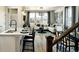 Stylish living area with kitchen island seating, hardwood floors, and mountain view windows at 14847 Arbor W Blvd, Thornton, CO 80602