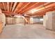 Unfinished basement with concrete floor, wood ceiling, and exposed ductwork; stairway unfinished at 9183 W Cedar Dr # 2, Lakewood, CO 80226