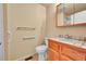 Bathroom features a toilet and sink with wood cabinets and a tile countertop at 9183 W Cedar Dr # 2, Lakewood, CO 80226