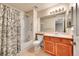 Bathroom features a shower-tub combo, tile floors, vanity, and large mirror at 9183 W Cedar Dr # 2, Lakewood, CO 80226