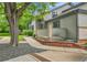 Side exterior of a home with a brick accent wall and mature trees at 9183 W Cedar Dr # 2, Lakewood, CO 80226