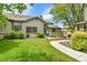 Exterior view of a home with a green lawn, mature trees, and sidewalk at 9183 W Cedar Dr # 2, Lakewood, CO 80226