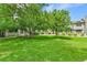 Large grassy area with mature trees in front of townhomes at 9183 W Cedar Dr # 2, Lakewood, CO 80226