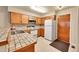 Kitchen features tile countertops, wooden cabinets, and white appliances at 9183 W Cedar Dr # 2, Lakewood, CO 80226