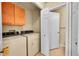 Laundry room featuring a washer, dryer, cabinets, and access to a door to a second room at 9183 W Cedar Dr # 2, Lakewood, CO 80226