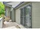 Townhome patio with security gate on sliding glass door, and brick pillar at 9183 W Cedar Dr # 2, Lakewood, CO 80226