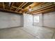 Unfinished basement with concrete floors, white walls, and a window at 14300 Waterside Ln # S2, Broomfield, CO 80023