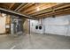 Unfinished basement with concrete floors, white walls, utilities, and laundry machines at 14300 Waterside Ln # S2, Broomfield, CO 80023