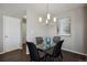 Modern dining area with a glass table, seating for four, and stylish light fixture at 14300 Waterside Ln # S2, Broomfield, CO 80023