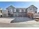 Townhome garages and driveways with stone accents and gray paint at 14300 Waterside Ln # S2, Broomfield, CO 80023