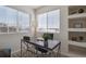 A home office area with 2 windows, a modern style desk, a gray area rug, and shelves in the background at 14300 Waterside Ln # S2, Broomfield, CO 80023