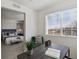 View from the home office looking into the bedroom, natural light from the window, and a modern desk at 14300 Waterside Ln # S2, Broomfield, CO 80023