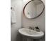 Powder room with a pedestal sink, an oval mirror, a white wall and a towel hanger at 14300 Waterside Ln # S2, Broomfield, CO 80023