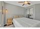 Comfortable bedroom features a ceiling fan, natural light, and mirrored closet doors at 1465 Red Cliff Way, Castle Rock, CO 80109