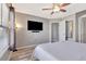Inviting bedroom featuring a large television and doorway leading to an ensuite bathroom at 1465 Red Cliff Way, Castle Rock, CO 80109