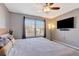 Comfortable bedroom features a flat screen tv, large windows, and stylish decor at 1465 Red Cliff Way, Castle Rock, CO 80109