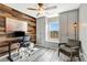Bedroom with wooden accent wall, built in storage near the window and hardwood-style floors at 1465 Red Cliff Way, Castle Rock, CO 80109