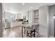 Open-concept kitchen featuring stainless appliances, sleek white cabinetry, granite counters and stylish breakfast bar at 1465 Red Cliff Way, Castle Rock, CO 80109