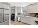 Modern kitchen featuring white cabinets, stainless steel appliances, and spacious countertops with luxury vinyl floors at 1465 Red Cliff Way, Castle Rock, CO 80109