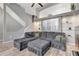 Stylish living area with gray sectional sofa, wood floors, and modern design elements at 1465 Red Cliff Way, Castle Rock, CO 80109