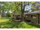 Spacious backyard features deck and patio dining, large tree and mature landscaping at 7150 S Curtice St, Littleton, CO 80120