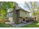 Backyard features a brick chimney and home exterior, seating areas on grass and brick pavers at 7150 S Curtice St, Littleton, CO 80120