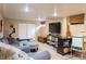 Spacious basement with a large television, cozy seating, and ample storage space at 7150 S Curtice St, Littleton, CO 80120