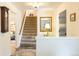 Inviting entryway featuring stylish decor and a staircase to the upper level at 7150 S Curtice St, Littleton, CO 80120
