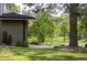 Exterior lawn with mature landscaping and walkway leading to street at 7150 S Curtice St, Littleton, CO 80120