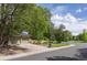 Exterior features long driveway leading to the two-car garage and well-manicured lawn at 7150 S Curtice St, Littleton, CO 80120