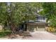 Charming exterior featuring a large front yard, and a two-car garage at 7150 S Curtice St, Littleton, CO 80120