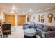 Cozy basement living room features seating with ottoman, decorative wall art, and two large closets at 7150 S Curtice St, Littleton, CO 80120