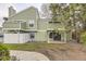 View of the back exterior of the green home with a small yard area at 4162 S Richfield S Way, Aurora, CO 80013