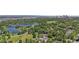 Aerial view showcasing the city skyline, a lake, green parks, and tree-lined residential streets at 1265 S Gaylord St, Denver, CO 80210