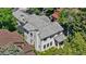 Aerial view of a home with a grey tile roof surrounded by mature trees and lush landscaping at 1265 S Gaylord St, Denver, CO 80210