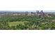 Breathtaking aerial view showcasing the city skyline, a lush park, and tree-lined residential areas at 1265 S Gaylord St, Denver, CO 80210